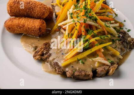 Esterhazy Roast Beef or Rostbraten with Root Vegetable Julienne, Croquettes and Sour Cream Gravy Stock Photo