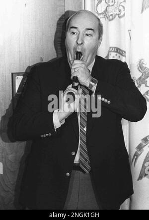 Pennsylvania State Treasurer R. Budd Dwyer, raises his left hand to