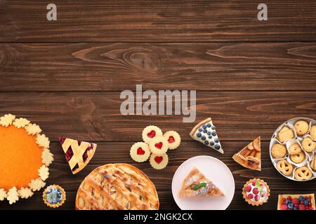 Flat lay composition with different delicious pies on wooden table. Space for text Stock Photo
