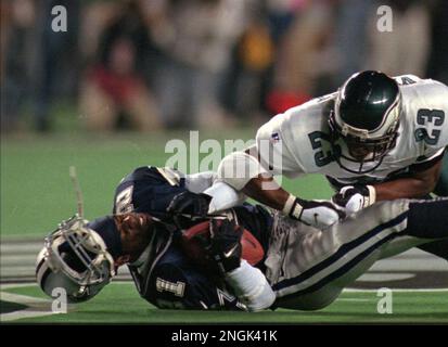 Cowboys Deion Sanders, left, has his helmet knocked off as he is tackled by  the Philadelphia Eagles Troy Vincent after Sanders caught a 39 yard pass  from Troy Aikman in second quarter action in Philadelphia, Monday Sept. 30,  1996. (AP Photo/Chris