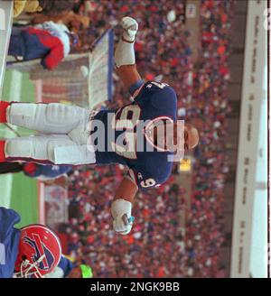 Buffalo Bills linebacker Cornelius Bennett, right, helps Houston Oilers  quarterback Warren Moon to his feet after sacking him in the third quarter  of their AFC playoff game at Rich Stadium in Orchard