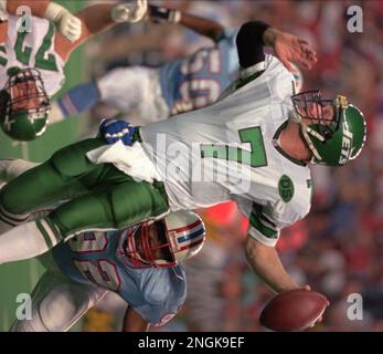 New York Jets quarterback Boomer Esiason (7) is grabbed from