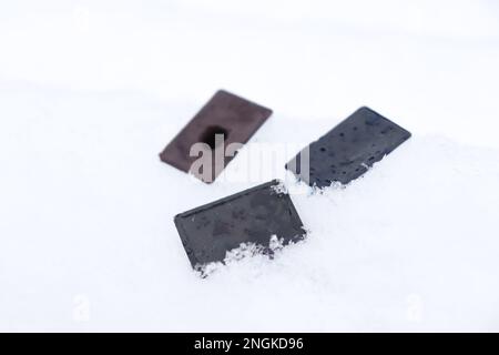 cuvettes with watercolors in the snow. Watercolor paints Stock Photo