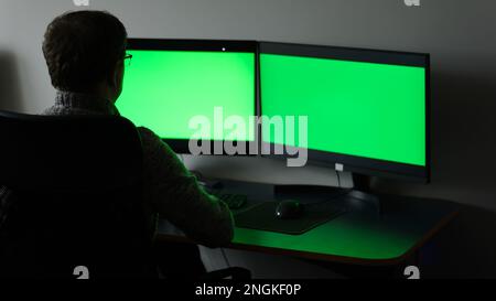 Close-up Focus on Person's Hands Typing on the Green Screen Chroma key Laptop Computer Keyboard. Software Engineer Create Innovative e-Commerce App. Program Development. High quality photo Stock Photo