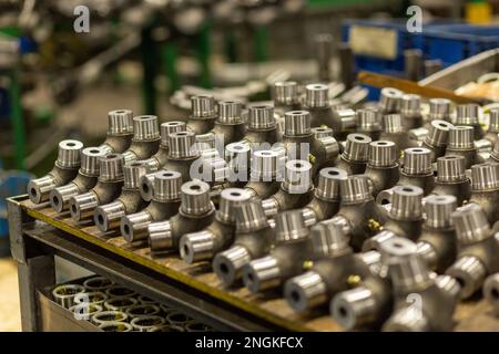 Universal joint crosses are on the workbench for further use in the production of cardan shafts. Stock Photo