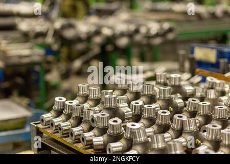 Universal joint crosses are on the workbench for further use in the production of cardan shafts. Stock Photo