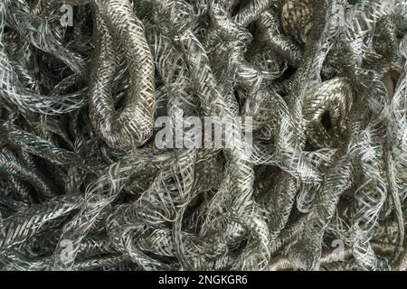 Silver metal copper wire scrap materials recycling of waste from manual wire tearing. Closeup of copper waste in the form of copper wires Stock Photo