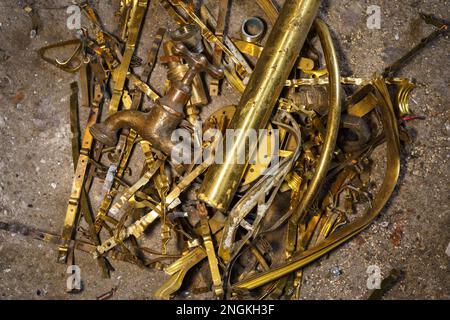 Old brass elements plumbing in recycling. Recycling of non-ferrous scrap. Stock Photo