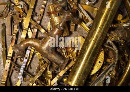 Old brass elements plumbing in recycling. Recycling of non-ferrous scrap. Stock Photo