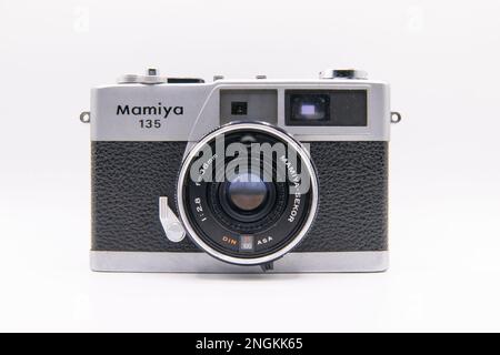 Closeup face on shot of Mamiya 135 EE rangefinder camera with Mamiya Sekkor 38mm lens on white background Stock Photo