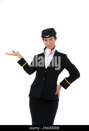 Portrait of a female flight attendant standing and welcoming passengers on board isolated on white background Stock Photo