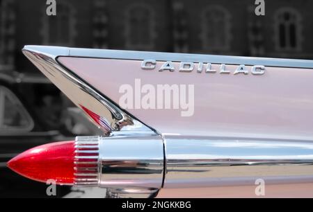 Close up of the rear wing of a pink Cadillac and red rocket rear light Stock Photo