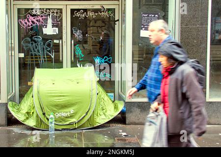 Glasgow, Scotland, UK  18th February, 2023. UK Weather:  Wet as rain sprouts umbrellas over the city centre. Homeless use pop up tents on the streets as umbrellas.  Credit Gerard Ferry/Alamy Live News Stock Photo