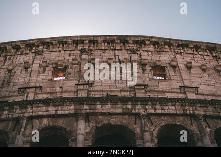 The iconic Colosseum stands tall, reflecting the ancient Roman civilization Stock Photo