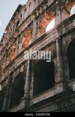 The iconic Colosseum stands tall, reflecting the ancient Roman civilization Stock Photo