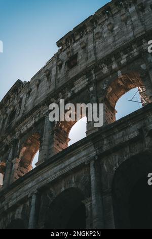 The iconic Colosseum stands tall, reflecting the ancient Roman civilization Stock Photo