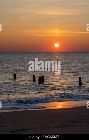 Waves gently lapping the shore at sunrise, Herring Point, Cape Henlopen State Park near Lewes, Delaware Stock Photo