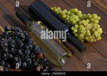 two bottles of red and white wine with grape Stock Photo