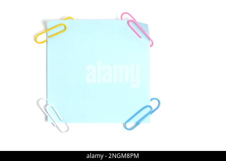 Blue paper sticker for written notes and paper clips on a white background Stock Photo