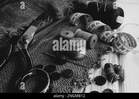 Retro tools for cutting and sewing. Needle with thread, thimble, sewing machine and scissors Stock Photo