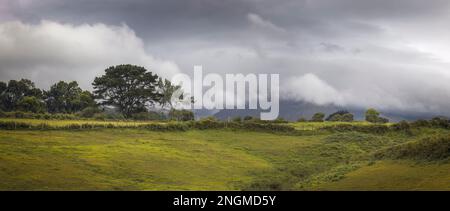 Striking Storm Clouds over Rolling Hills.in Asturias, Spain Stock Photo