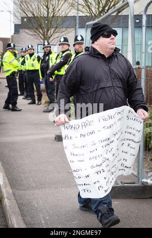 Rotherham, UK. 18th Feb, 2023. An anti-immigration demonstrator walks towards the counter demonstration outside the Holiday Inn hotel which is housing refugees. An anti-immigration protest was organised outside the hotel housing asylum seekers waiting for claims to be processed. A counter-protest was also staged by Stand Up To Racism. Credit: Andy Barton/Alamy Live News Stock Photo