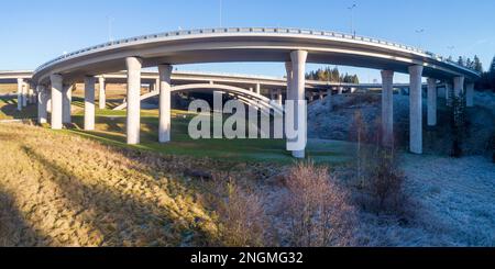 High slip ramp on pillars connecting  new highway called Zakopianka, supported by arc structure in Poland near Skomielna Biala village. Low angle view Stock Photo