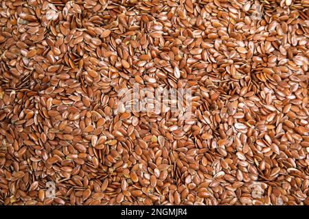 Heap of flax seeds as background, top view. Veggie food Stock Photo
