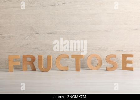 Word Fructose made of wooden letters on table Stock Photo