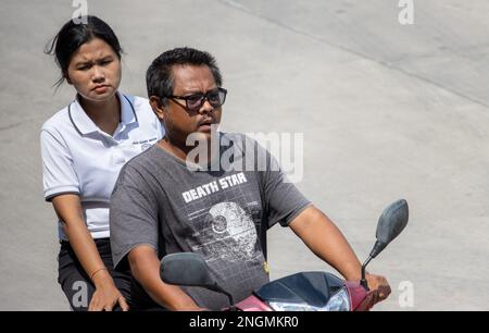 SAMUT PRAKAN, THAILAND, FEB 13 2023, The pair rides on motorcycle at the street. Stock Photo