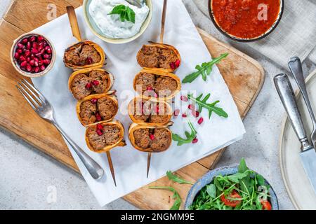 Beyti - Turikish lamb kofte-style kebab wrapped in flatbread Stock Photo