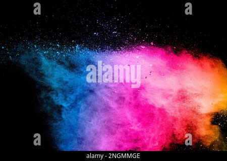Explosion of colored powder isolated on black background. Abstract colored background. Stock Photo