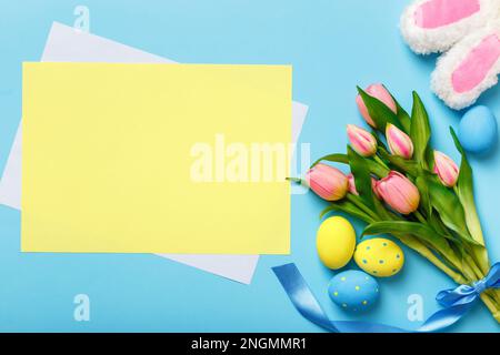 Easter card. Bouquet of tulips eggs rabbit ears. Empty sheet of paper with space for text and copy space Stock Photo