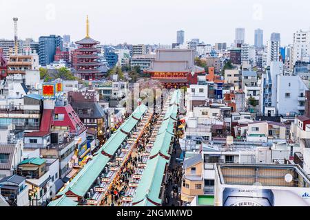 Tokyo. Asakusa shrine and Sensoji temple and pagoda at end of the Nakamise, a crowded souvenir shopping street leading to the second gate. Blue hour. Stock Photo