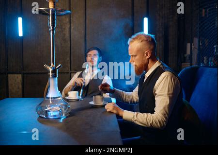 Good friends meeting in hookah lounge, relax concept Stock Photo