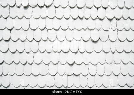 old wooden shingles siding painted white - background texture pattern with copyspace Stock Photo