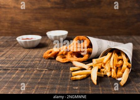 A Burger, Golden French Fries, And Onion Rings Presented On A Wooden 