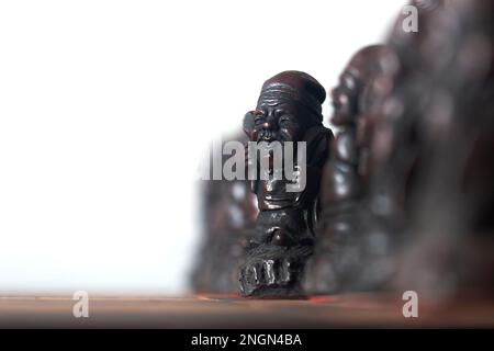 Chinese oriental chess pieces, with a row of figures representing pawns. Antique chess set and board Stock Photo