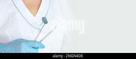 Different tools for dental care in docktor hand. Dental background. With copy space, close-up. Oral dental hygiene concept. Stock Photo