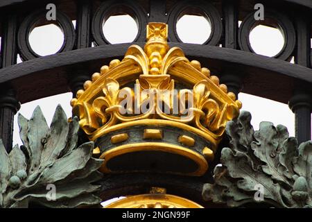 beautiful royal insignia of the Royal British family on the gates of Buckingham Palace, a London royal residence and the administrative headquarters Stock Photo