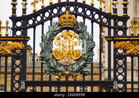 beautiful royal insignia of the Royal British family on the gates of Buckingham Palace, a London royal residence and the administrative headquarters Stock Photo