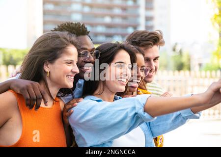Multiracial group of friends making a selfie with phone in the city - friendship, happiness and joyful concept Stock Photo