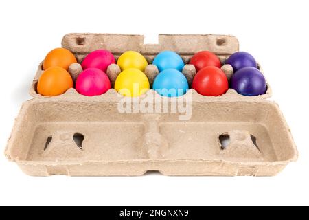 Brightly colored confetti eggs in a brown egg carton, side view Stock Photo