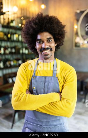 Latin american young small business owner smiling at camera at bar restaurant Stock Photo