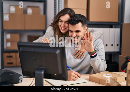 Man and woman ecommerce business workers having video call at office Stock Photo