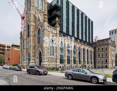 The Lucas is an eight-story glass-and-steel residential condo built inside the restored shell of a gothic-styled stone church in Boston’s South End. Stock Photo