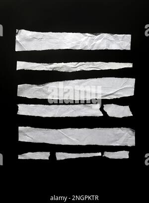 Set of pieces of crumpled paper stripes isolated on black, design elements Stock Photo