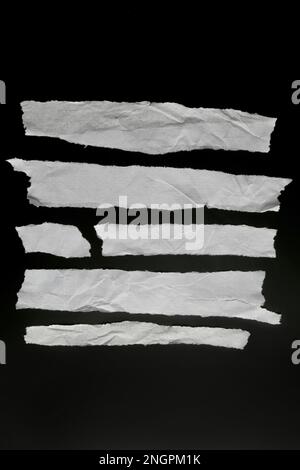 Set of pieces of crumpled paper stripes isolated on black, design elements Stock Photo