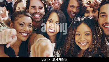 We need you on our side. a group of happy businesspeople pointing at you while standing in their workplace lobby. Stock Photo
