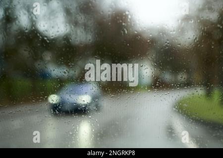 Road in heavy rain. Water falling or raining in front of the car on the road or street. Driving car in rain. Blurred background. Stock Photo